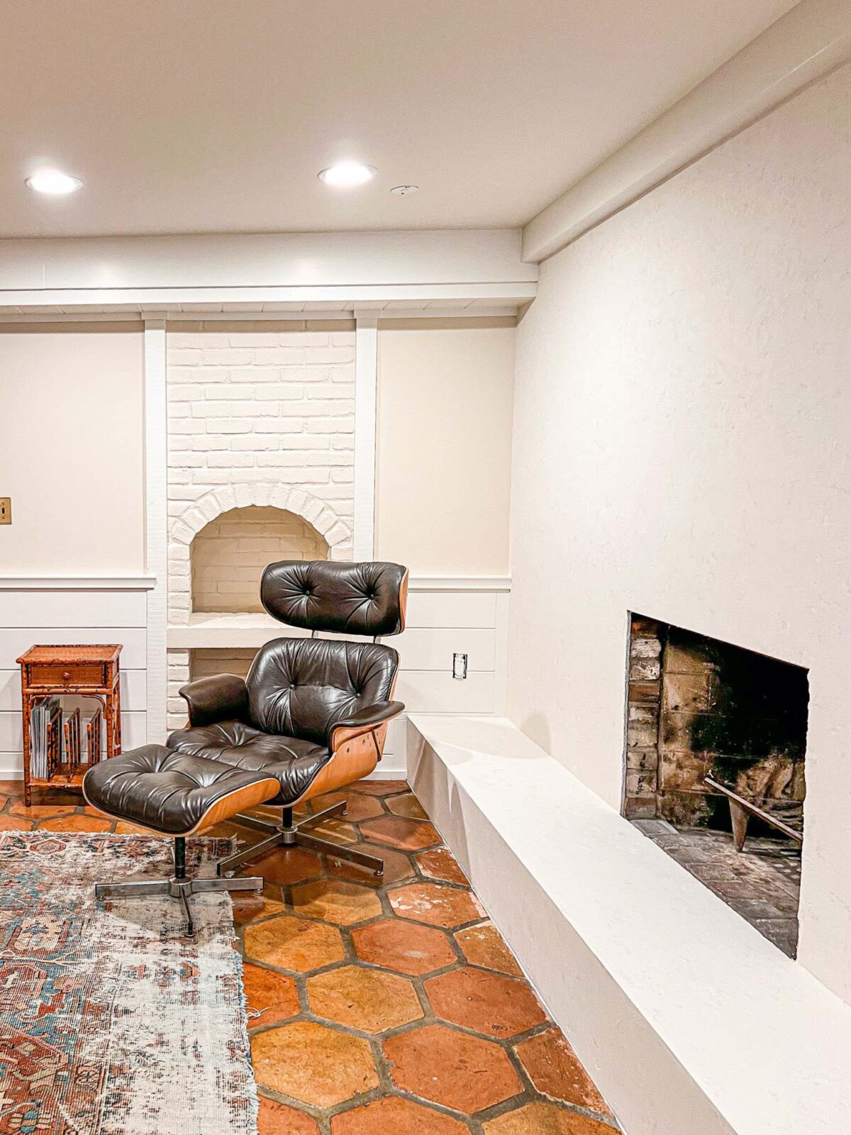 A cozy basement family room uses a mix of Sail Cloth and White Dove paint colors, both by Benjamin Moore.